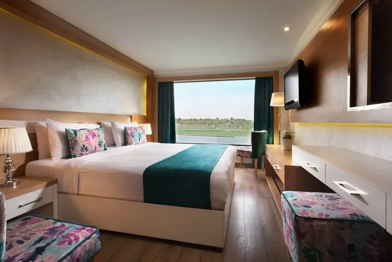 MS Acamar Royal Suite — 52.2 square metres, king-size bed, panoramic Nile-view window, the most spacious suite in our Classic fleet, Egypt 2026