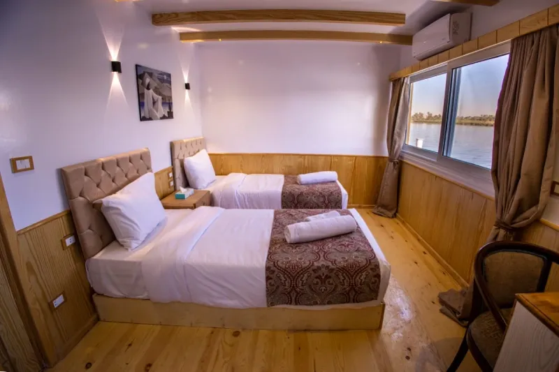 Akhnaton Dahabiya Panoramic Suite 21m² with private terrace overlooking the Nile River — boutique wooden sailing dahabiya Esna to Aswan Egypt 2026