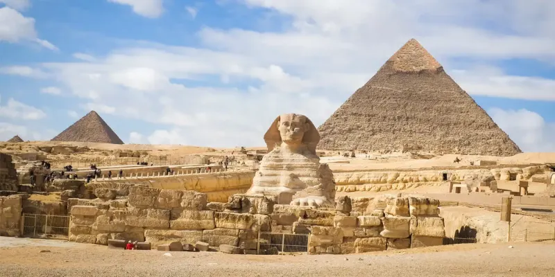 Great Sphinx of Giza full body south view Egypt 2026 — 73 metres long with Dream Stele between paws and three pyramids behind