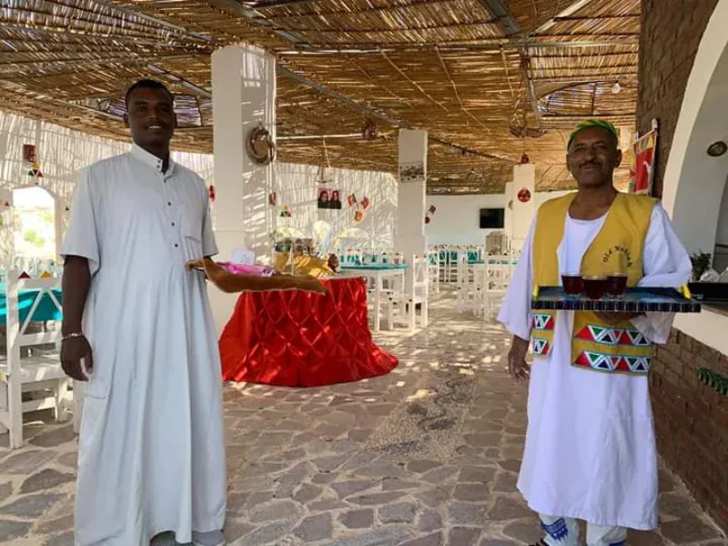 Bissaw Nubian village hospitality courtyard karkadé tea Egypt — Dahabiya guests welcomed by Nubian family