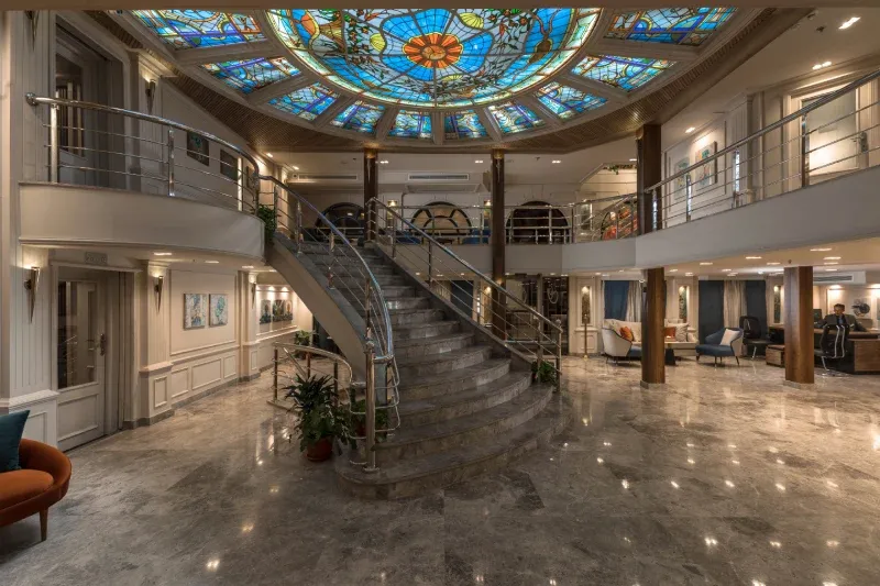Royal Beaurivage Nile Cruise stained-glass mosaic lobby ceiling with LED-lit columns and sweeping staircase — ultra-modern Egyptian Nile cruise 2026