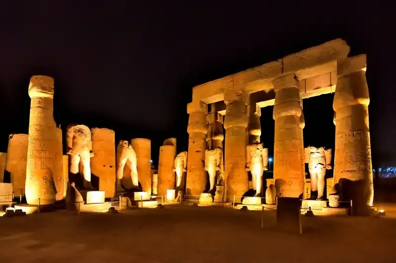 Karnak Temple Sound and Light Show Luxor Egypt night — illuminated pylons and columns reflected in Sacred Lake