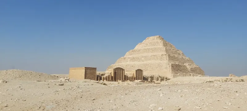 Saqqara necropolis desert plateau with the Step Pyramid of Djoser and surrounding mastaba tombs — Egypt's largest ancient cemetery, 32km from Cairo, visitor guide 2026