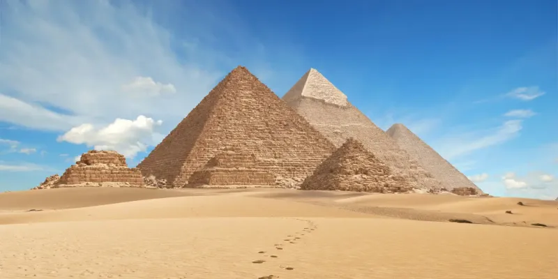 Pyramids of Giza Egypt 2026 — three pyramids on the Giza plateau with Cairo skyline in the background