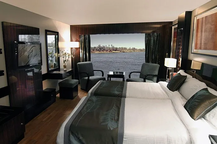 Le Fayan Nile Cruise Deluxe Room — floor-to-ceiling window, Jacuzzi, boutique design Egypt 2026