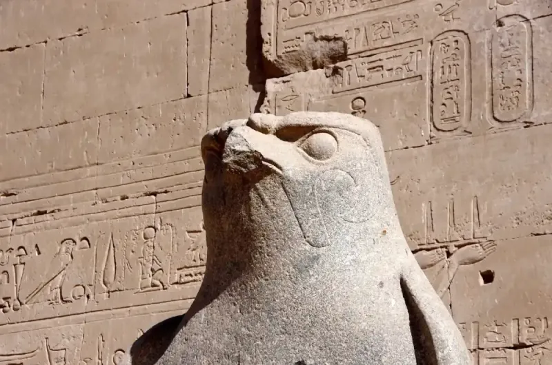 Temple of Edfu First Pylon 36 metres Egypt 2026 — tallest pylon in Egypt with two black granite Horus falcon statues at entrance