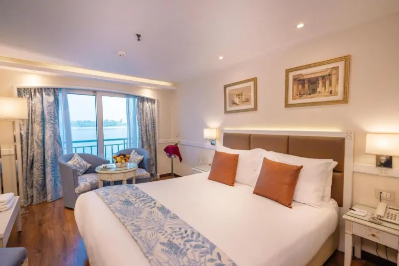 MS Tower Prestige standard cabin — large French windows with panoramic Nile views, flat-screen TV, minibar, safe, shower, upper deck, 5-star deluxe Egypt 2026