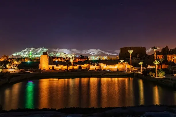 Karnak Temple Sound and Light Show Luxor Egypt night — illuminated pylons and columns reflected in Sacred Lake