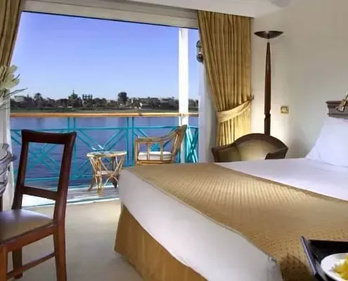 Sonesta Moon Goddess deluxe cabin with private balcony and floor-to-ceiling sliding glass doors — Nile view, full-size bathtub, free WiFi, 5-star classic Egypt 2026