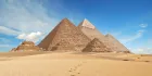 Pyramids of Giza Egypt 2026 — three pyramids on the Giza plateau with Cairo skyline in the background